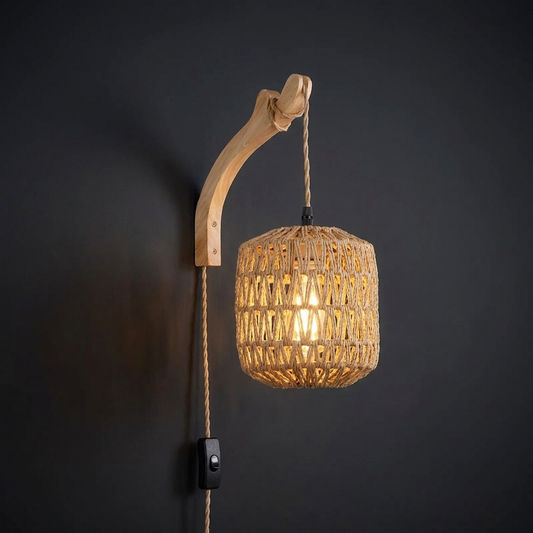 Bamboo lantern sconce, drum shade on a curved arm, against a deep charcoal wall