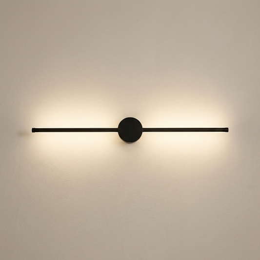 Black I-shaped linear LED wall light, 80 cm, lit against a pale sand wall