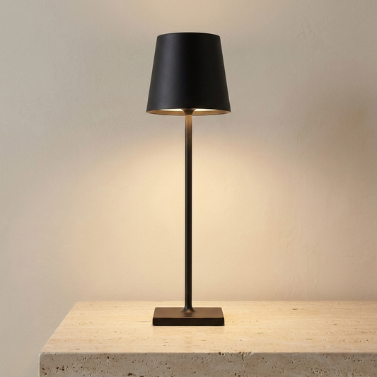 Cordless bar table lamp in matte black on a travertine surface