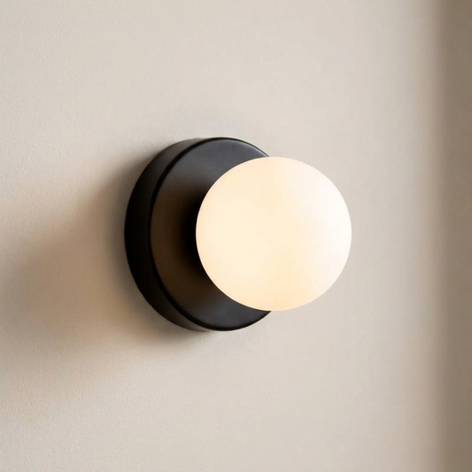 Macaron mini wall sconce with a black glass shade