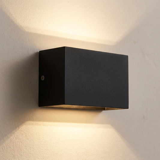 Up and down wall sconce in black on a bone wall