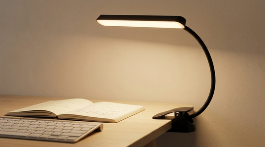 Cordless task light clamped to a desk over an open notebook